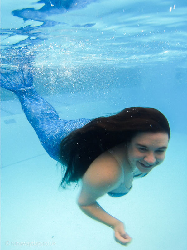 Carla underwater in a mermaid tail